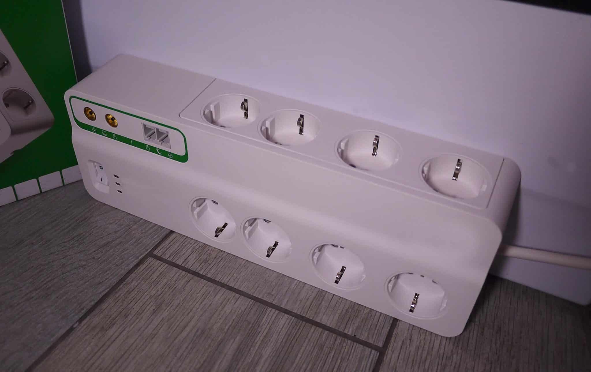 Power strip with multiple sockets on a wooden floor.